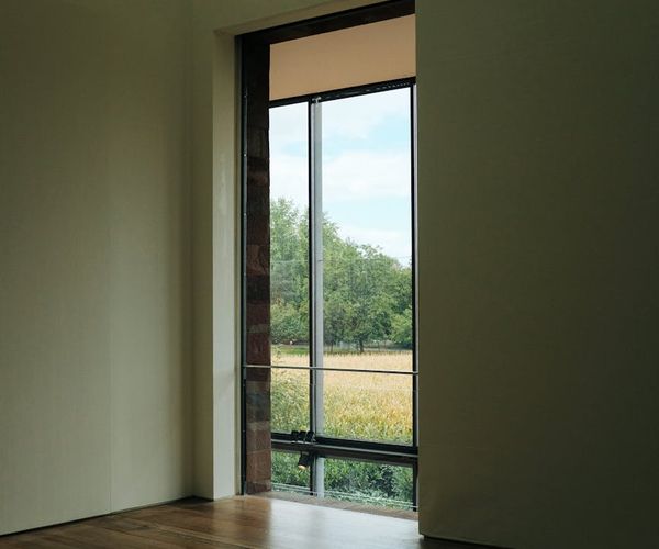 Bright and clean fitness studio with large windows and minimalist decor.