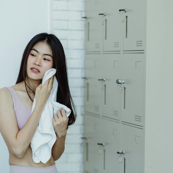 Person smiling and looking refreshed after a workout session.
